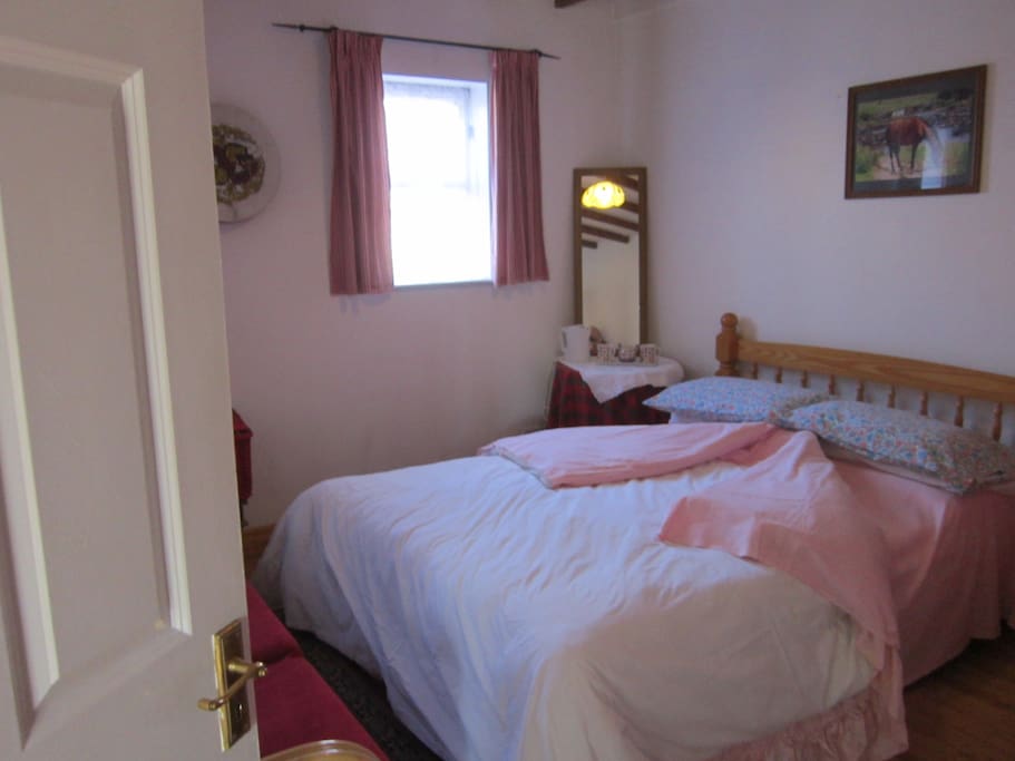 Double room is downstairs, view to the front and has exposed beams on the ceiling.