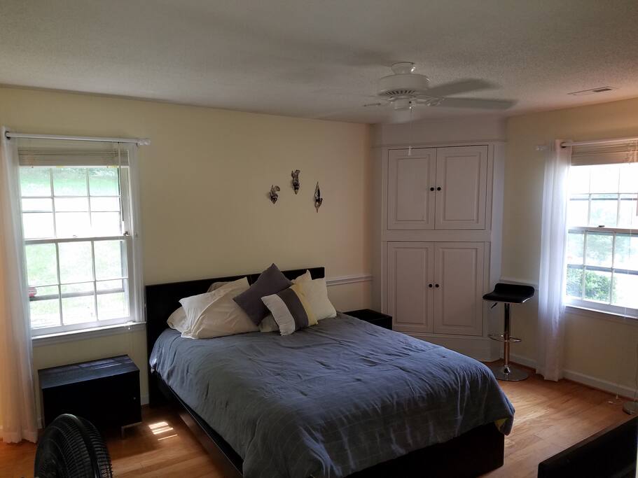 Master bedroom. Just out of view in the foreground is a smart flat screen hooked up to satellite TV.