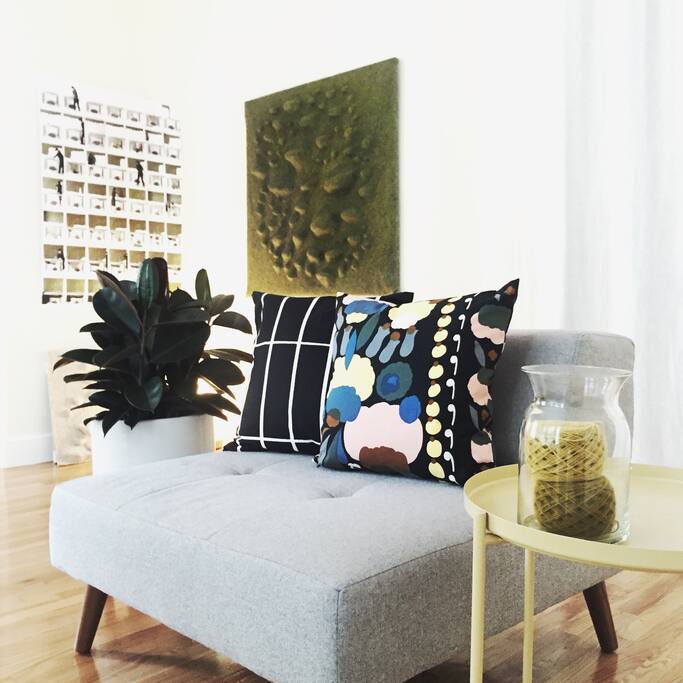 Single sofa, with a rubber plant next to it, and my felted sculptural interactive wall art behind.