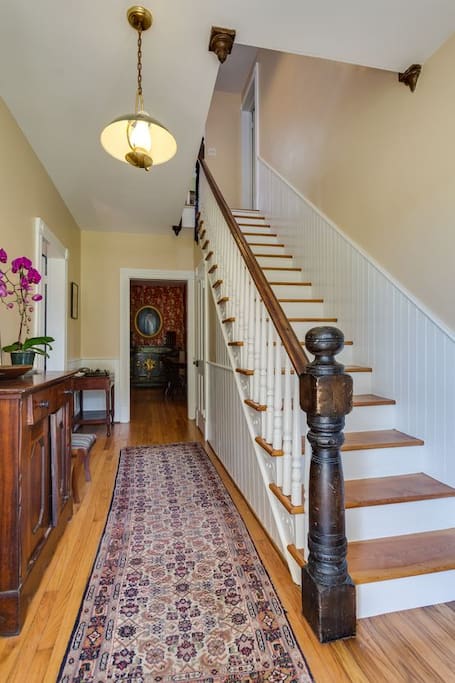 Inviting foyer with hardwood floors and wainscoting