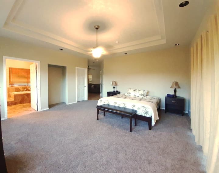 Glavni apartman s kliznim vratima do terase, pogledom na kupaonicu i ured s prostorom za sjedenje.
