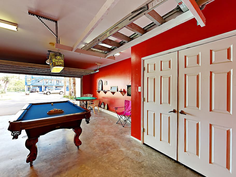 The garage has been converted into a game room, complete with a pool table and poker table.