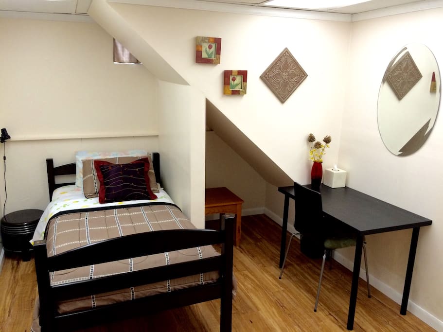 The room, located under the stairs, with tiny non-standard windows, walk-in closet and tables.