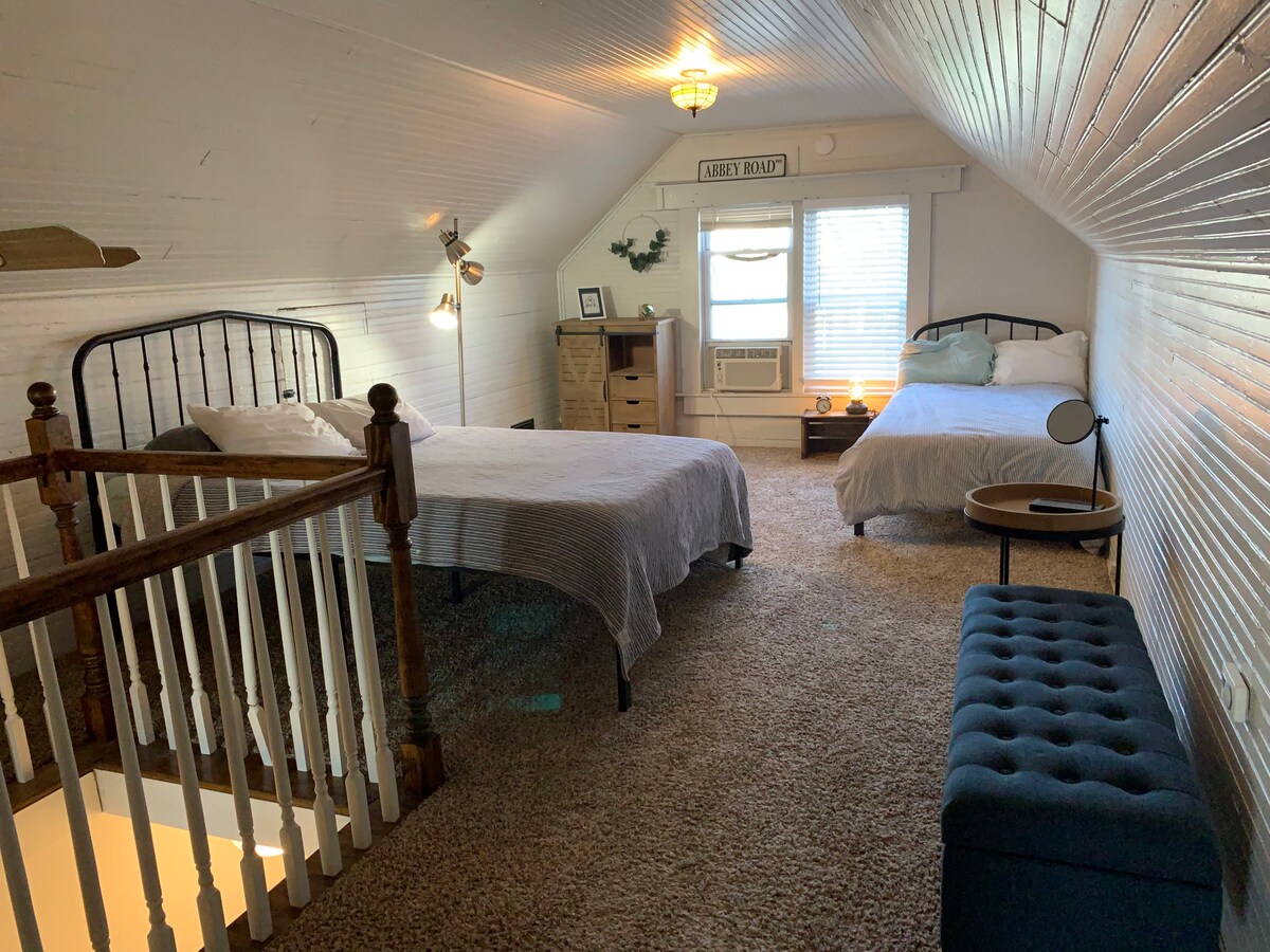 Upstairs sleeping area. Blue ottoman opens up for storage.