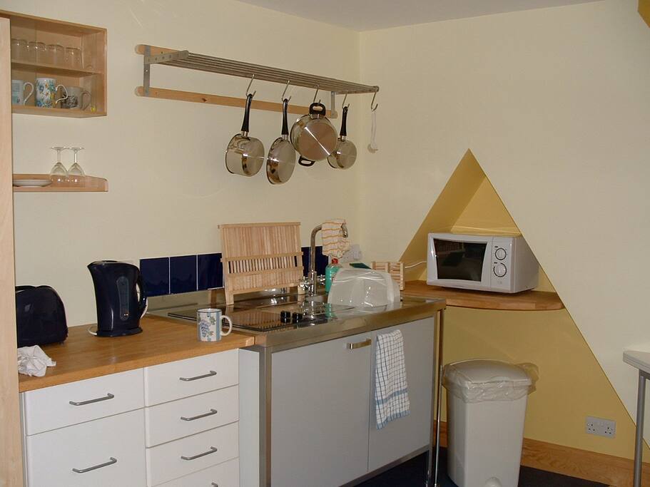 Fridge, 2 rings, cooking utensils sink and microwave