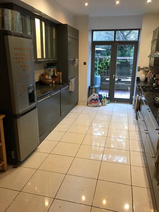 Open plan kitchen with amenities & double doors leading to the back patio