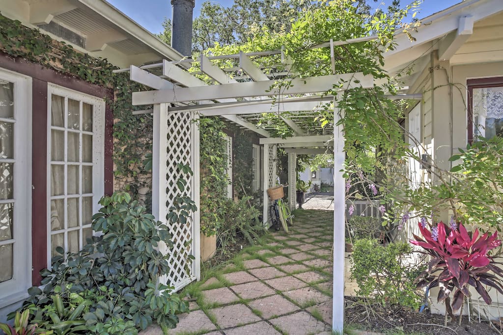 Arbors draped in Mandevilla vines, Jasmine, and Wisteria adorn the backyard.