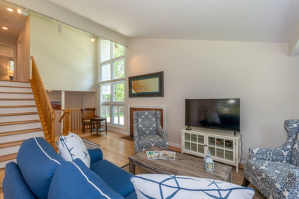 Living room and 1 of 3 televisions.