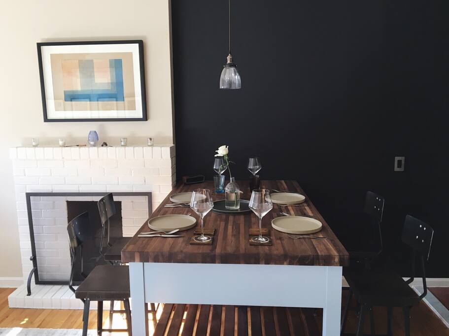 This custom-designed kitchen island doubles as a kitchen prep counter and dining table with bar stools. Handmade Japanese ceramics and Finnish glassware compliment the color palette of the interior.