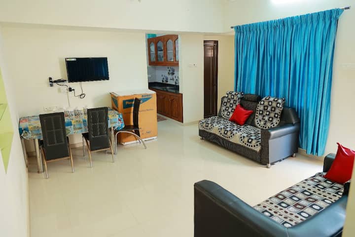 Hall with TV, Sofa, Dinning Table and attached Bathroom.