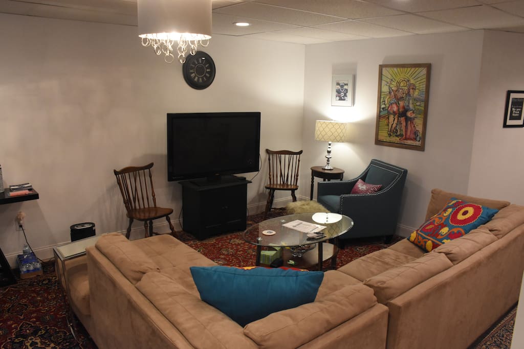 Common area, sectional and 55" flat Screen with directTV, NFL package, and Apple TV