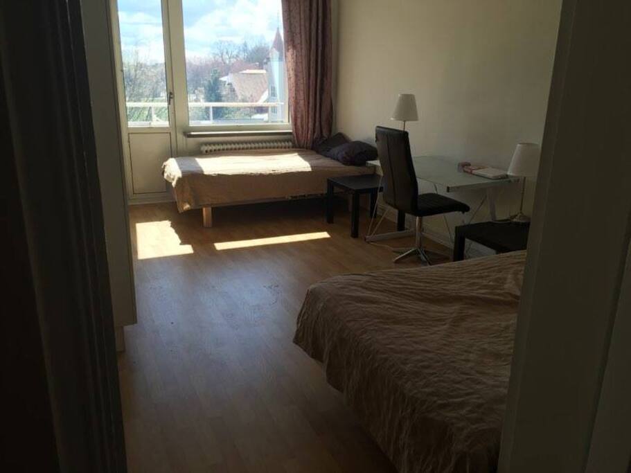 2 bed room with a cozy desk and chair.