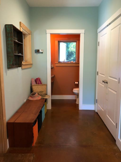 Just upon entry you’ll find a closet and bench for your items, and a half bath.