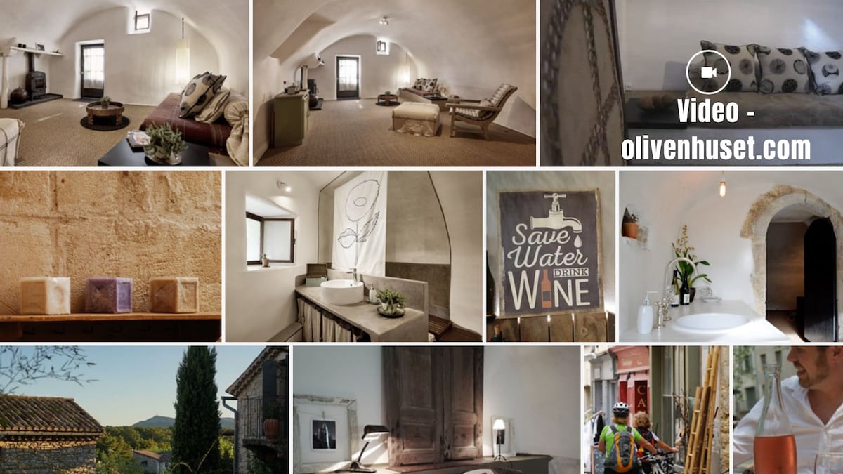 An open living area features a soft seating arrangement with light-toned furnishings. A cozy atmosphere is created by the arched ceiling and natural light streaming in from the window. Decorative elements include neutral-toned art pieces and a subtle arrangement of modern decor items.