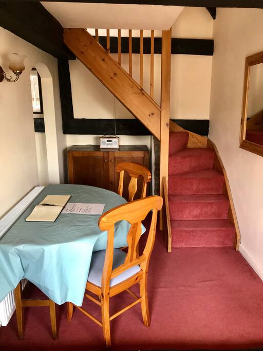 Dining table and stairs up to bedrooms