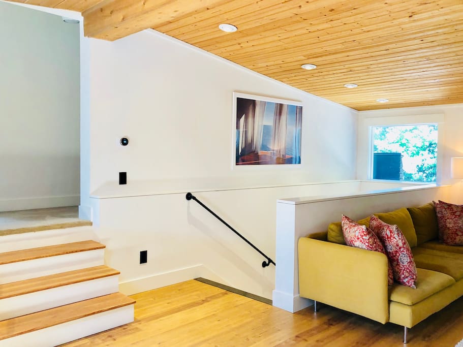 Living room and stairs to upper Queen and Twin bedrooms and down to yoga/conference room