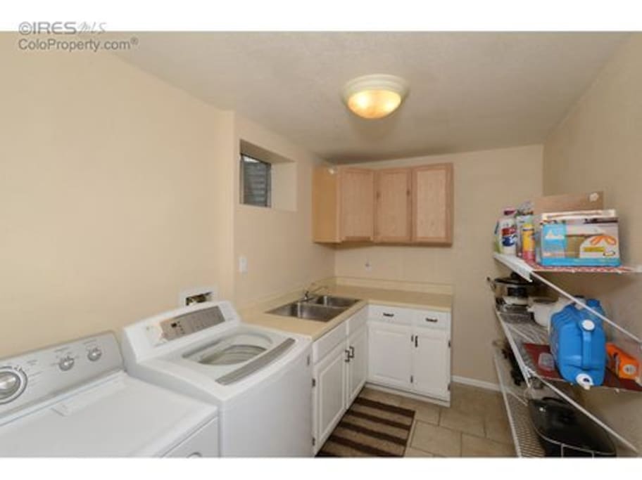 Laundry room in basement; with microwave.