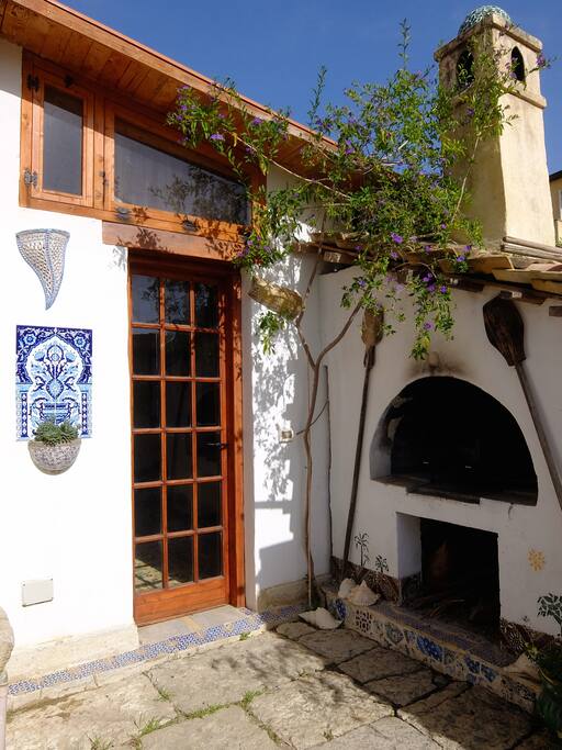 The entrance of the room and wood-fired oven.