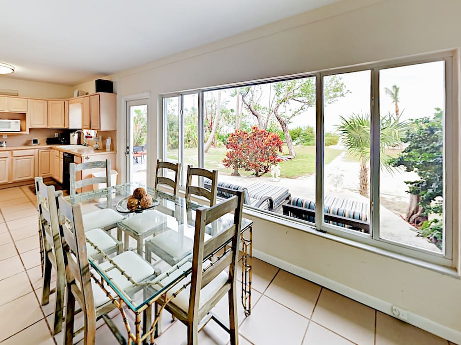 Wall-to-wall windows provide incredible sunset views in the formal dining area.