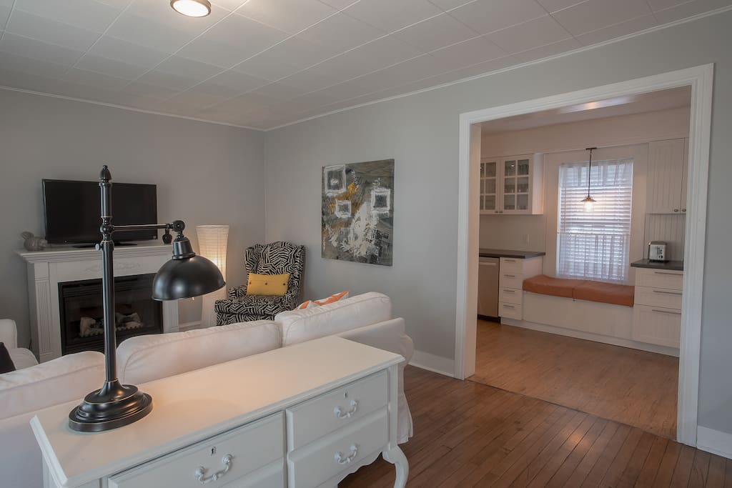 Our cozy living room steps away from our fully equipped kitchen!