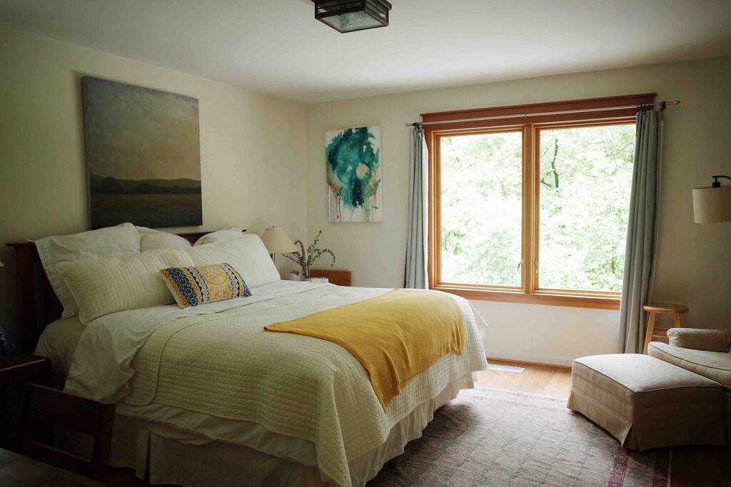 A cozy king size bed with a view.