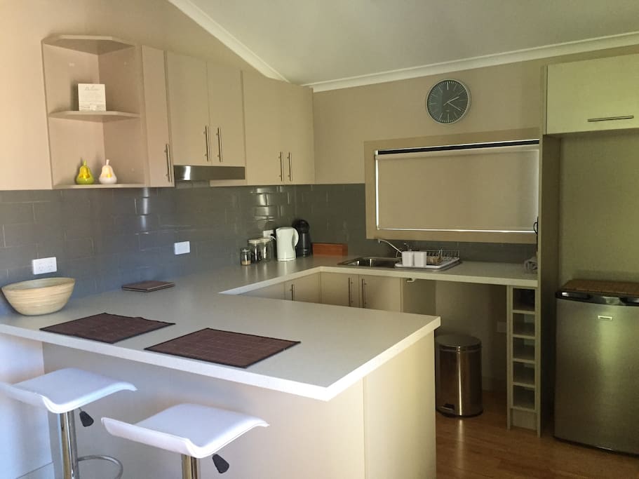 A modern kitchen with cooking facilities ( Hot plates and Microwave ) and a convenient breakfast bar.