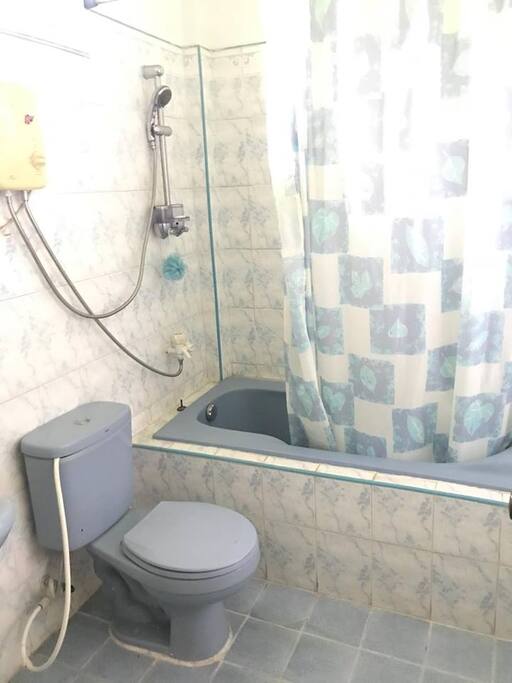 toilet and bath with bathtub and heater