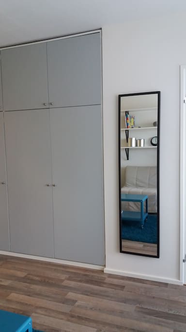Mirror and cupboards opposite the smaller sofabed