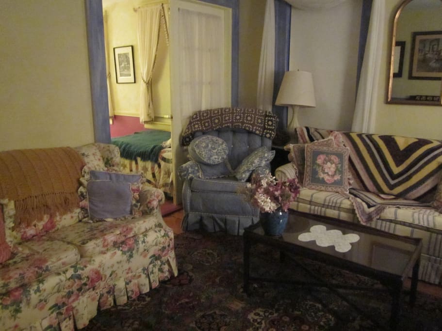 The sofa bed is on the right (not set up). There is a comfy chair, two love seats and a desk. If the sofa bed isn't needed, this makes a nice sitting room.