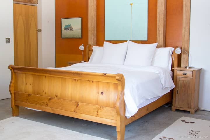 Master bedroom with king bed on ground floor.