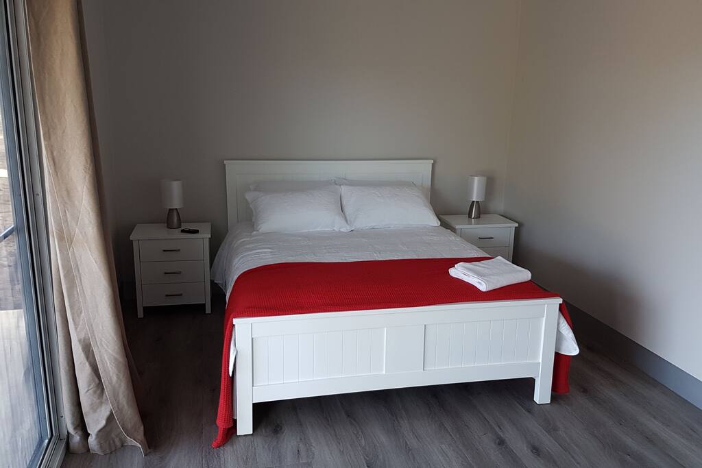 Second bedroom with queen-size bed and wardrobe