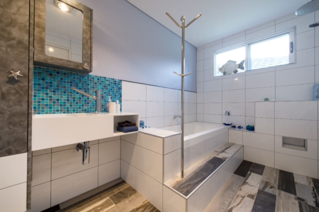 Your bathroom with rain-shower, heated flooring (if required), hairdryer, draw-space, heated towel rail and toiletries.