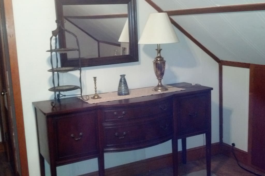 Antique buffet in room with antique lamp