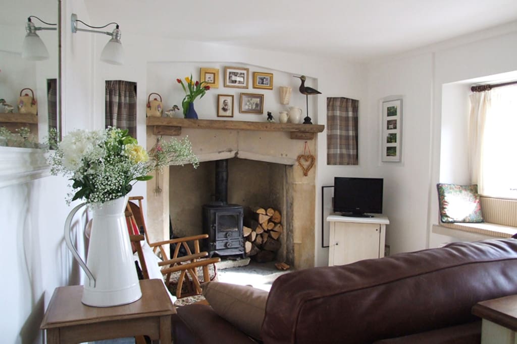 Living Room with original fireplace and wood burning stove