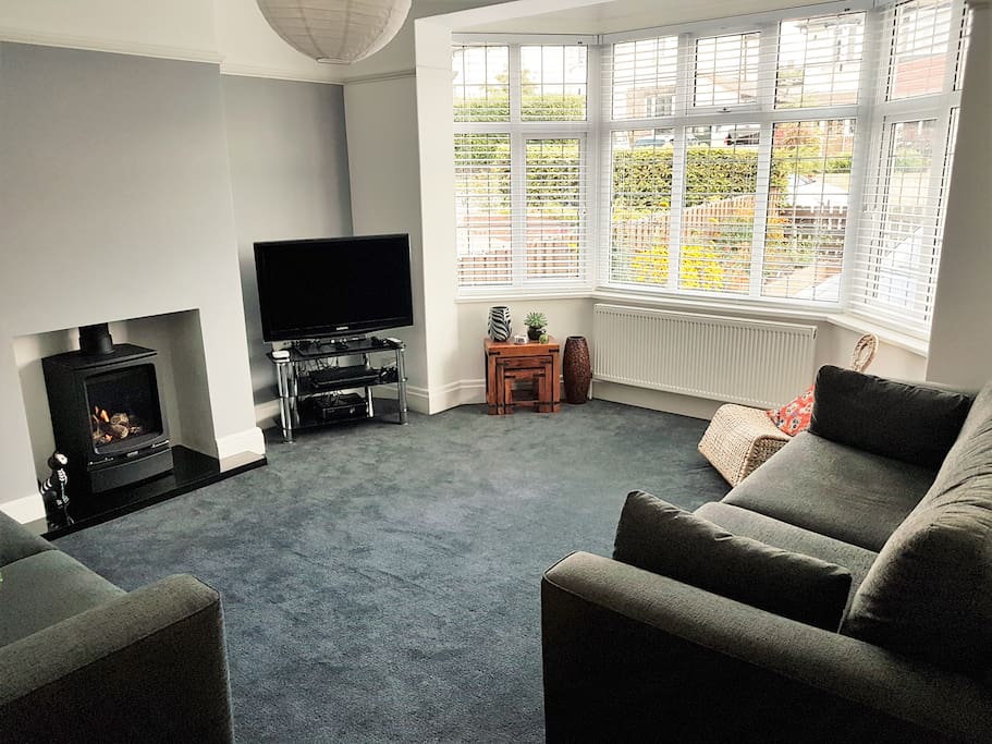 Bright spacious front living room with gas stove