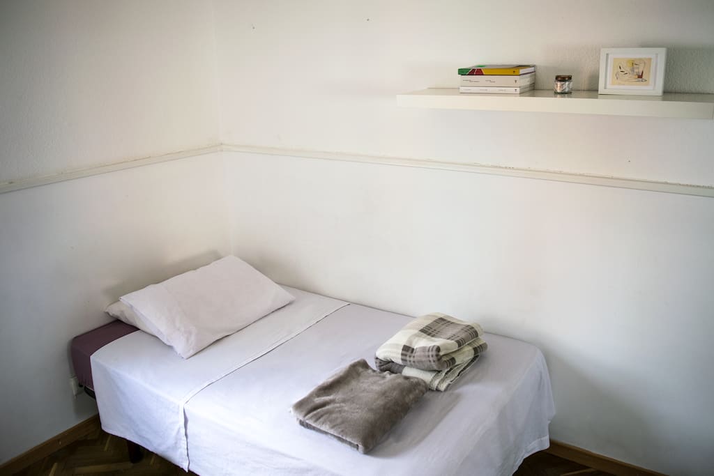 Full view of the bed. Blankets, normal pillows and an ortopedic pillow is given to your use.
