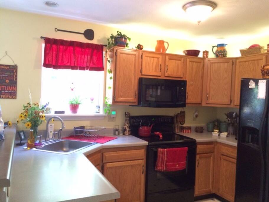 A bright and sunny kitchen overlooks the backyard , deck & pool area as well as the living room. Great for socializing!