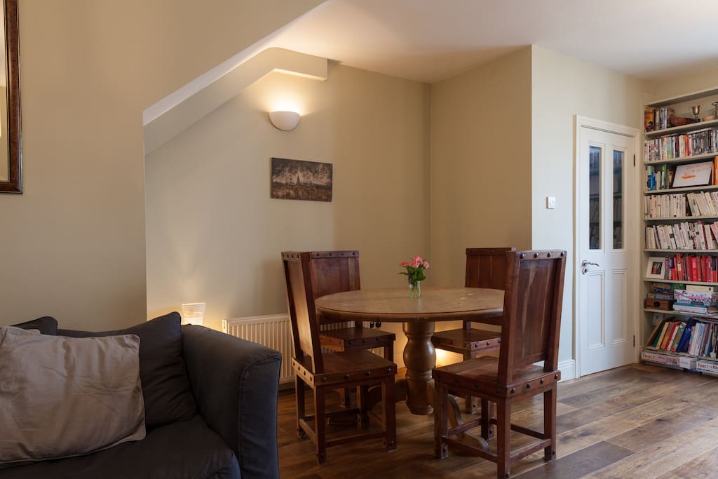 Spacious living room with brick fireplace and iron stove