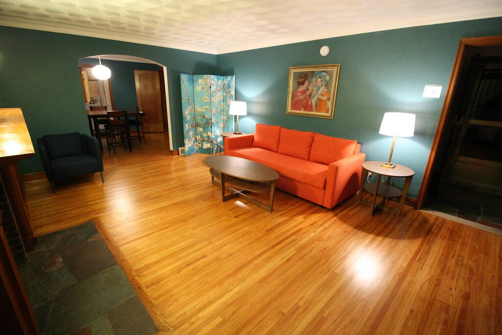 This red couch is a queen size pull out bed and the screen is used to make the room private.