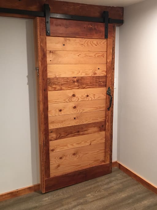 Your privacy and serenity are ensured with this lovely barn door, skillfully crafted by Dave himself! The entire door is constructed from two 1910's ceiling joists following the renovation of this space.