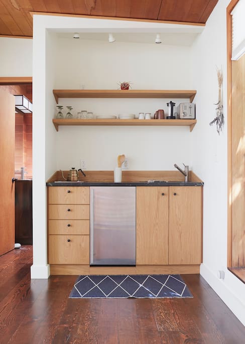 Kitchenette contains a double burner Miele stove top, refrigerator, sink, and everything you need for cooking and cleaning