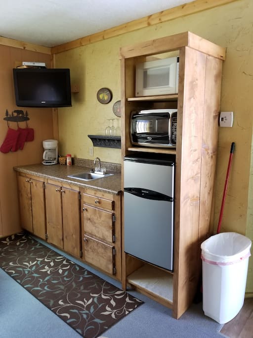 Small kitchen, fridge, microwave and coffee maker.