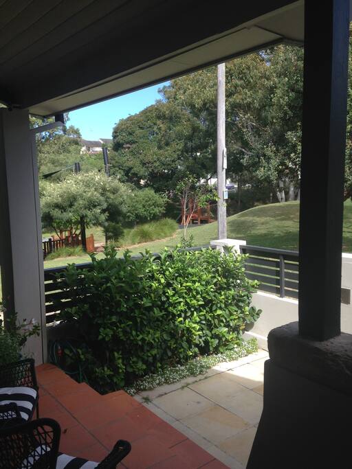 Soaking up the sun and reading the papers from the front balcony while watching the kids in the park!