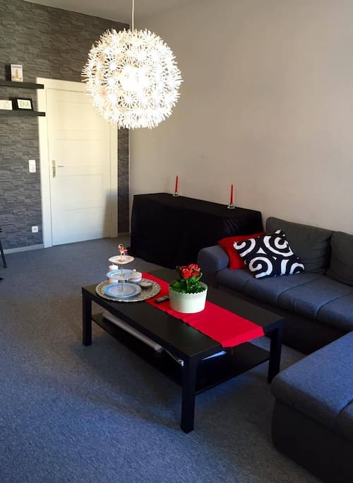 Spacious red and gray Living Room with big Couch Bed and Television -part one