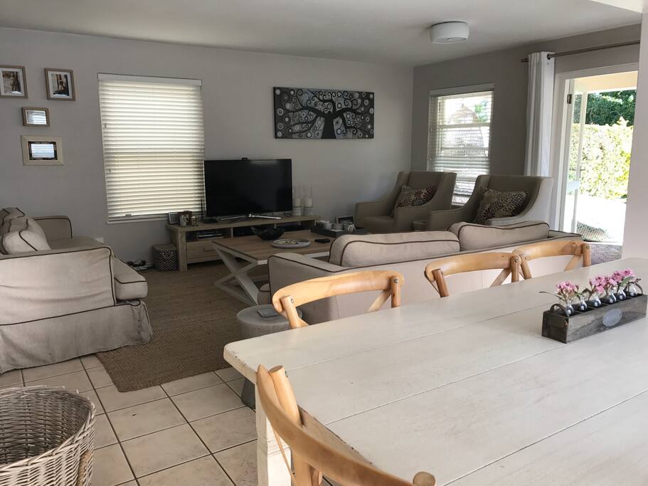 Open plan lounge, kitchen and dining area, leading to outside with a small garden and lovely common pond area