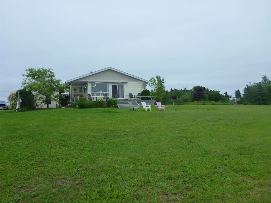 Large deck and lawn face Caribou Harbour.