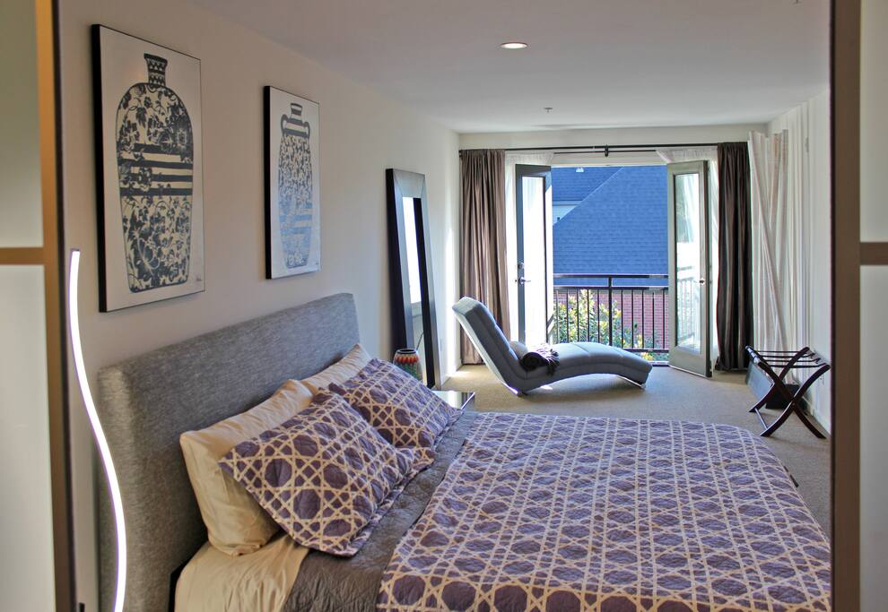 The spacious master bedroom suite occupies the entire top floor and features a king bed with a Tuft & Needle mattress and ample space for a Frontline Essential EZ Queen Bed for guests 7/8