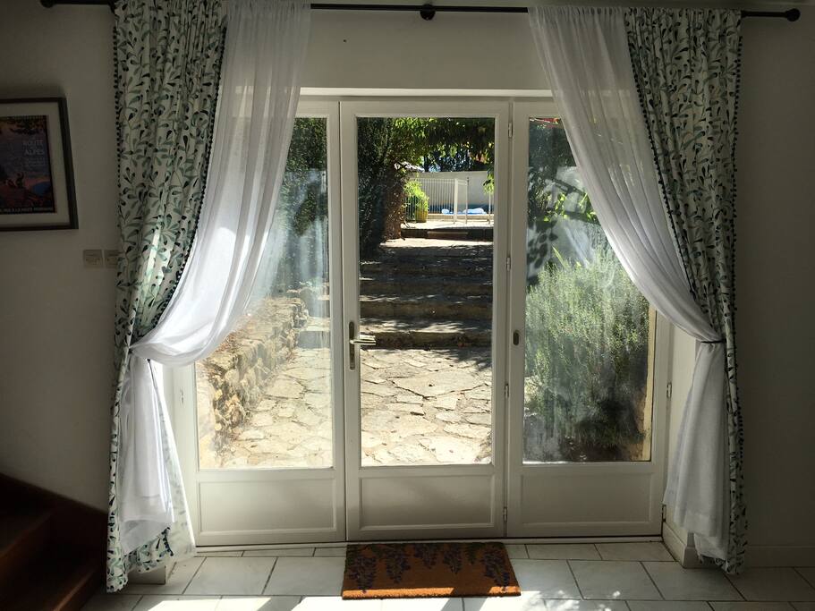 A view towards the pool and outside BBQ and dining area