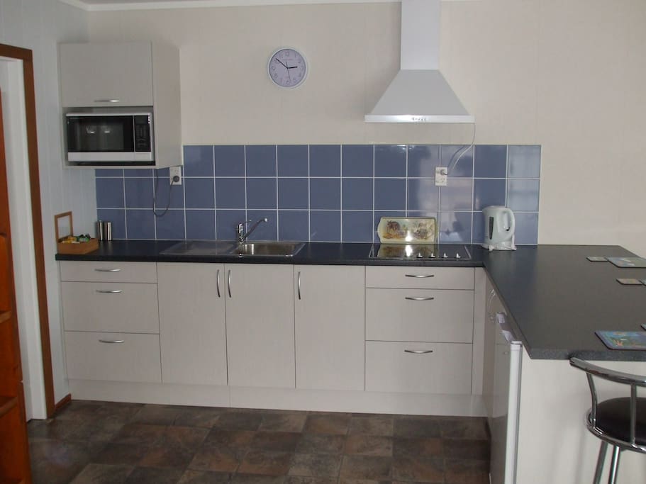Kitchen with seating for four at bar.