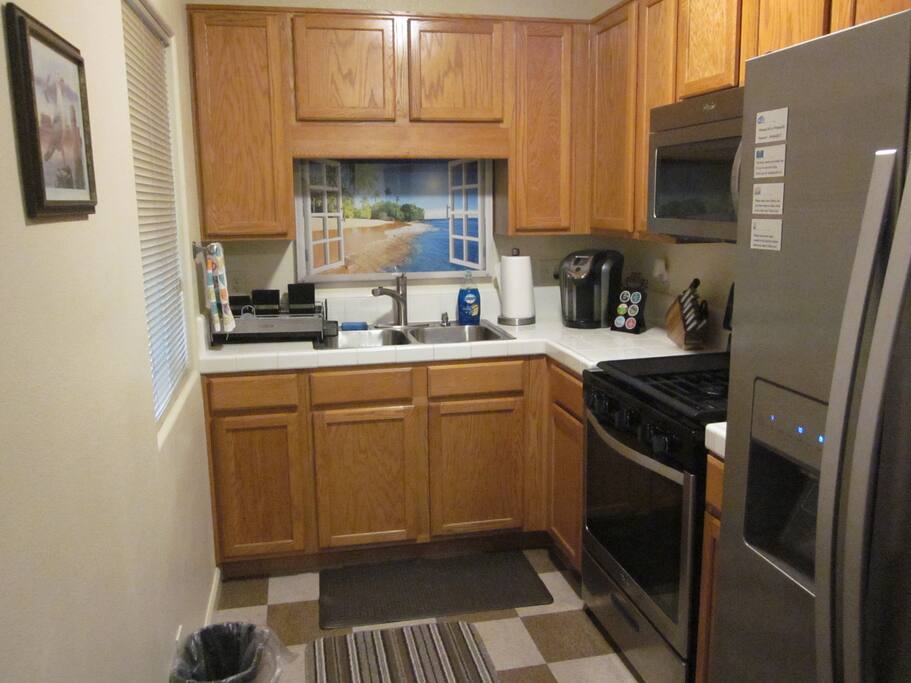 Full kitchen with stove, microwave and Keurig coffee maker